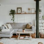 Bright and cozy living room with Scandinavian design and modern home decor, featuring a sofa and plants.